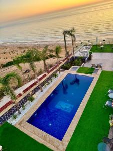 an overhead view of a swimming pool next to the beach at Royal Room 5 Chambre Royale in Asilah