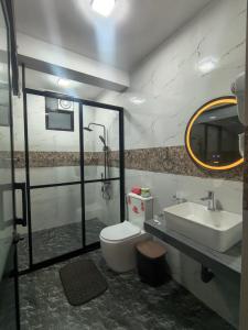 a bathroom with a toilet and a sink at Ella Mount Relax Cottage in Ella +115 photos