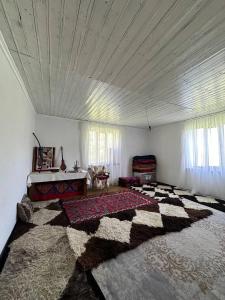 a large bedroom with a large rug on the floor at Uruyat Nomad guesthouse in Naryn +4 photos