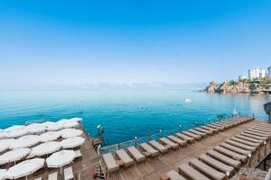 a row of chairs and umbrellas on a dock in the water at Massimo Hotel - Adults Only 'Ex La Boutique Hotels' in Antalya +76 photos