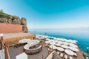 a deck with white umbrellas and the ocean at Massimo Hotel - Adults Only 'Ex La Boutique Hotels' in Antalya