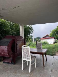 a table and a chair next to a piano at REBL Suites in Sutješčica