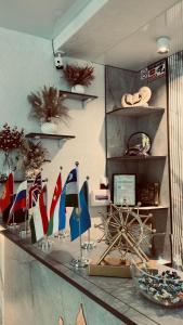 a room with flags on a counter with shelves at Diltoj Hotel Tashkent in Tashkent