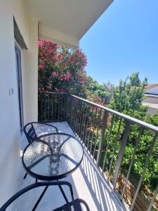 a balcony with a table and chairs on it at Apartmani Oleander in Bar
