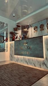 a large sign for a hotel in a room at Diltoj Hotel Tashkent in Tashkent