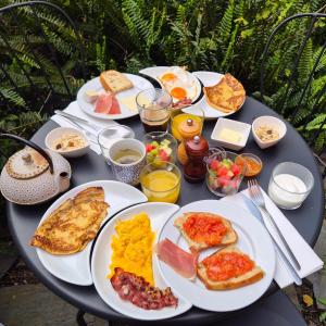a table with plates of breakfast food on it at Tings Lisbon in Lisbon