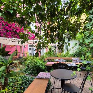 a patio with tables and chairs under a tree at Tings Lisbon in Lisbon +117 photos