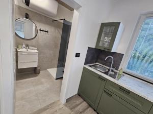 a bathroom with a sink and a mirror at Roma in Portorož +114 photos