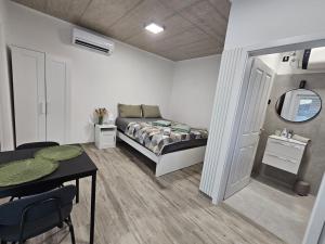 a bedroom with a bed and a table and a table sidx sidx sidx at Roma in Portorož