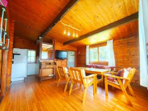 a dining room with a table and chairs in a cabin at CAMPING A GRANDELLA in El Franco