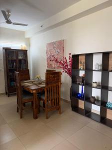 a dining room with a wooden table and chairs at Apartment for rent in Noida