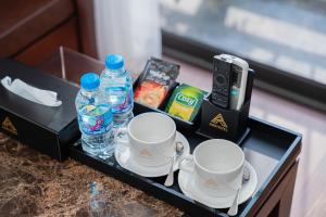 a tray with two cups and two bottles of water at A89 Hotel & Spa Hanoi in Hanoi