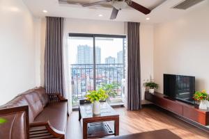 a living room with a couch and a large window at A89 Hotel & Spa Hanoi in Hanoi