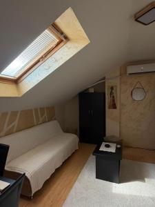 a bedroom with a bed and a skylight at Nebeski kutak in Valjevo