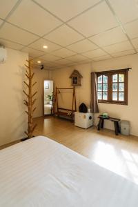 a bedroom with a bed and a room with a table at Always Boutique Stay in Pai