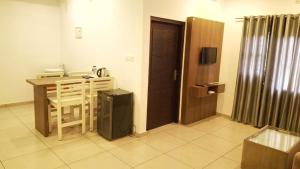 a room with a table and a table and a door at Hotel Wayanad Gate in Wayanad +8 photos