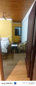 a room with a bedroom with a bed and a table at AB lodge in Coimbatore