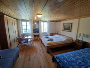 a bedroom with a bed and a table and chairs at Bergengel in Scharnachtal 