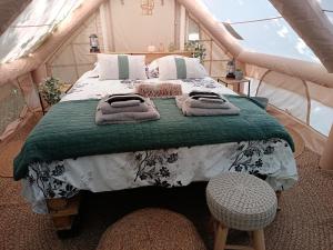 a bedroom with a bed in a tent at THOUARS Rivière LODGE KAËLI in Maulais