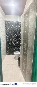 a bathroom with a shower with a toilet in it at AB lodge in Coimbatore +5 photos