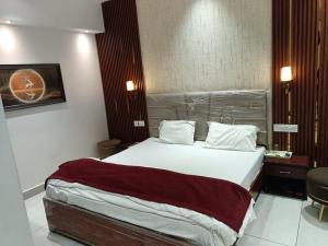 a bedroom with a large bed in a hotel room at Hotel Deepjot in Karnal