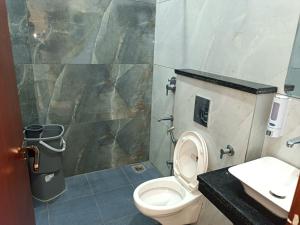 a bathroom with a toilet and a sink at Hotel Deepjot in Karnal
