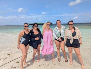 a group of women standing on the beach at PASIFIC OCEAN TOUR's in Wasini Island