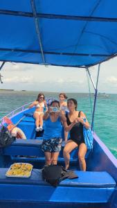 a group of people sitting on a boat in the water at PASIFIC OCEAN TOUR's in Wasini Island