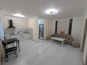 a kitchen and living room with a couch and a table at Erevanyan House in Pʼarakʼar