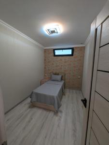 a small bedroom with a bed and a window at Erevanyan House in Pʼarakʼar