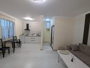 a living room and kitchen with a couch and a table at Erevanyan House in Pʼarakʼar +2 photos