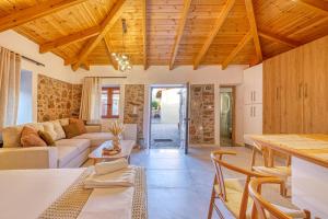 a living room with a couch and a table at Thymele Stone House in Lygourio