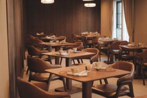 a dining room filled with tables and chairs at Pousada Murano in Campos do Jordão