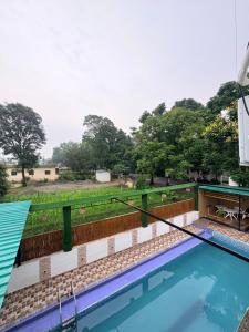a view of the pool from the roof of a house at Lagoon Bites in Jhājra +14 photos