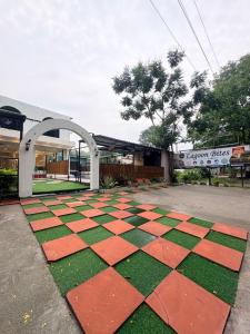 a checkered floor in front of a building at Lagoon Bites in Jhājra