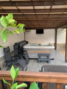 a patio with a table and chairs under a roof at Пътепис in Bratsigovo +15 photos