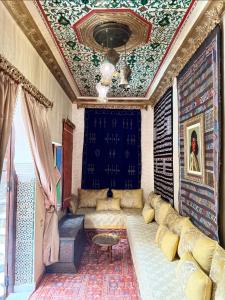 a living room with a couch and a ceiling at Sherezade Riad in Tétouan