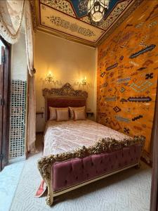a bedroom with a bed in a room with a wall at Sherezade Riad in Tétouan