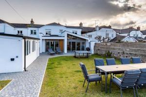a patio with a table and chairs in a yard at Number 15 - Bude Cornwall in Bude