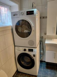 a washer and dryer in a small kitchen at Siva's Apartment in Svolvær