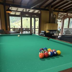 a pool table with a group of balls on it at Pousada Ritmos da Terra - Estadia de 6ª a Domingo in Angelina