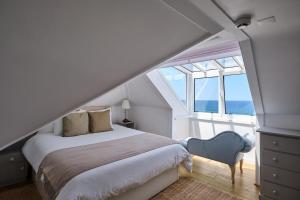a bedroom with a bed and a blue chair at Casal Santa Virginia in Sintra +97 photos