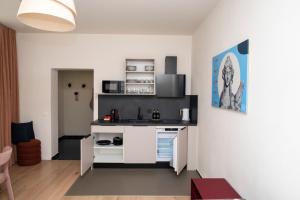 a kitchen with a white island in a room at Miki Stays - 700m zum Ring in Vienna
