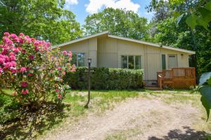 a small house with pink flowers in the yard at Central AC 3 Min Walk to Pond in Barnstable