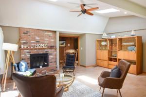 a living room with chairs and a brick fireplace at Central AC 3 Min Walk to Pond in Barnstable
