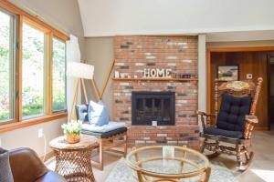 a living room with a brick fireplace with two chairs at Central AC 3 Min Walk to Pond in Barnstable +27 photos