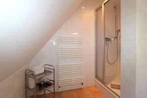a bathroom with a shower and a sink and a shower at Haus Koppelweg FW-Fisch in Ahrenshoop +15 photos