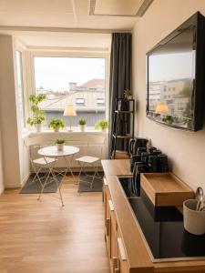 a kitchen with a stove and a window at Avenyn Hostel, former Le Mat in Gothenburg