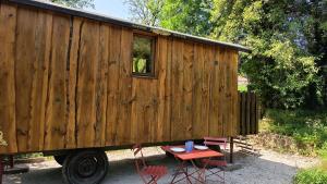 a tiny house sitting on the back of a truck at La Roulotte by Maison Maliga in Saint-Pierre-de-Curtille