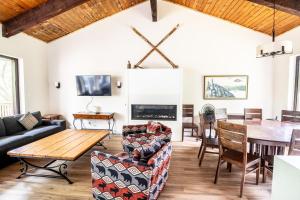 a living room with a table and a dining room at Blue View Chalets in Blue Mountains